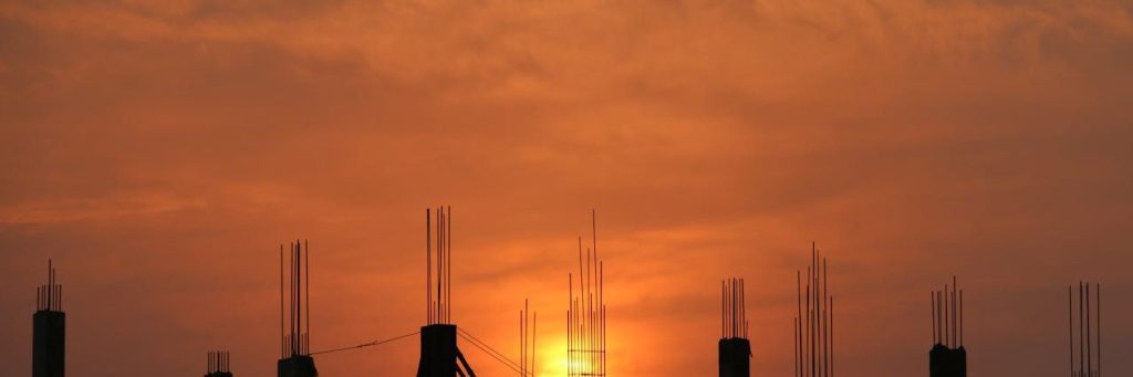 Silhouette of Men in Construction Site during Sunset